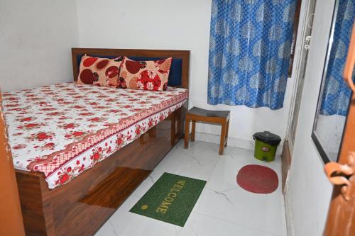 a small bedroom with a bed and a window at Bhojpur Guest House in Gaya