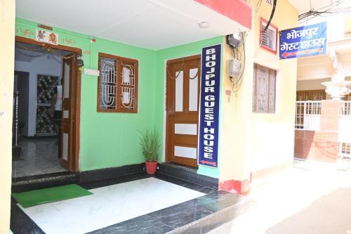 a building with a sign on the side of it at Bhojpur Guest House in Gaya