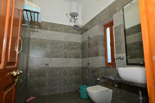 a bathroom with a sink and a toilet at Idar Haveli in Jodhpur