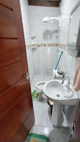 a bathroom with a sink and a toilet at Kitnet_Familiar 2/4 in Boa Vista