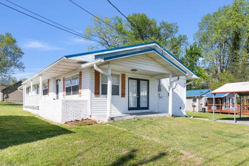 a small white house with a blue roof at Country Charmer in Sevierville
