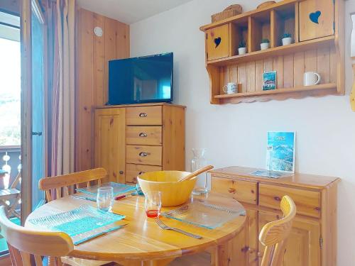 une salle à manger avec une table en bois et une télévision dans l'établissement Studio La pointe des Aravis 3 by Interhome, à Saint-Gervais-les-Bains