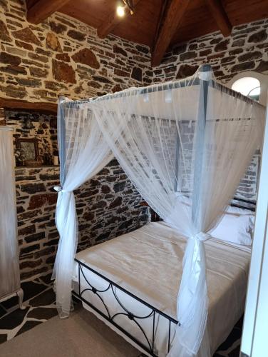 a bedroom with a bed with a canopy at Moonstone retreat in Mesokhória