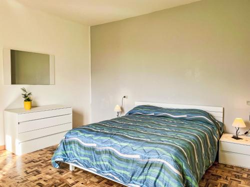 a bedroom with a bed and two dressers and a tv at Apartment Pippo by Interhome in Masina
