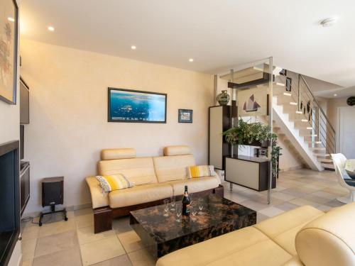 a living room with a couch and a table at Holiday Home Ty Pors Ar Pagn by Interhome in Penmarcʼh