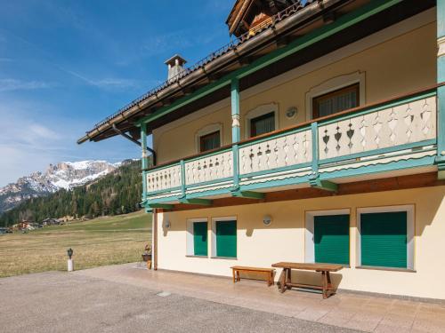 a building with a balcony and a bench in front at Apartment Ardoney by Interhome in Campitello
