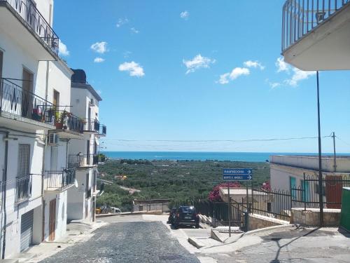 a car driving down a street between two buildings at Brezza Marina in Mattinata