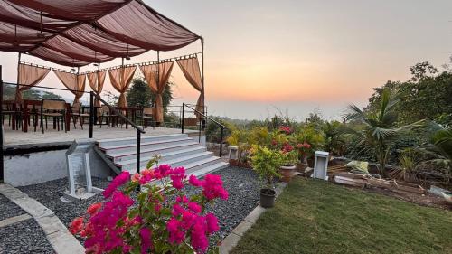 a garden with a set of stairs and flowers at La Vida Villa in Bārsiv