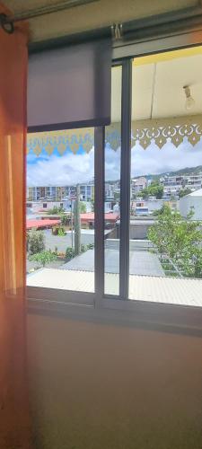 a window in a room with a view of a building at CHEZ LILIANE in Saint-Denis