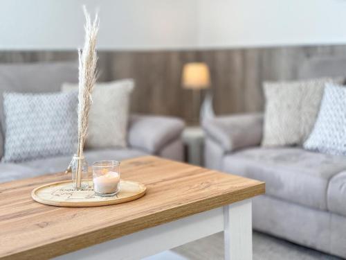 a coffee table with a candle on top of it at Wenkendeck in Fehmarn