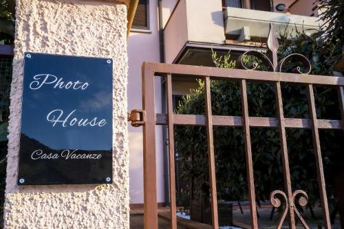 a sign on a gate in front of a house at Photo House Collodi La Villetta in Collodi