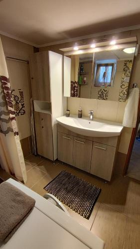 a bathroom with a sink and a mirror at Anatoli Kavala in Kavála