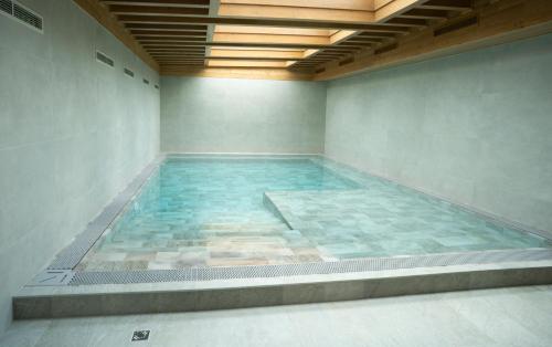 a large pool of water in a room at REMZ Apartments & Wellness in Dorog