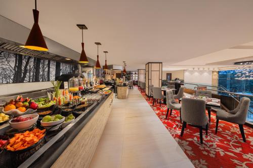 a buffet line at a hotel with fruits and vegetables at Fortune Select Exotica, Navi Mumbai - Member ITC Hotels' Group in Navi Mumbai