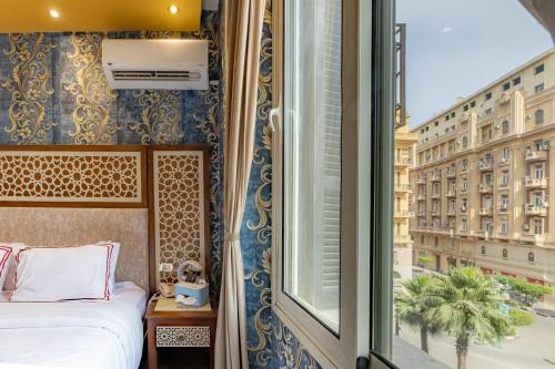 En eller flere senge i et værelse på Cairo Inn