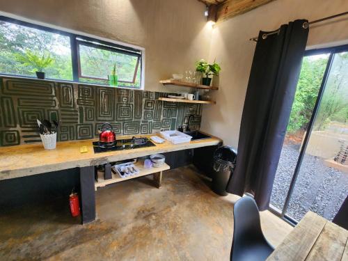a room with a desk in a room with windows at Hartbeest Bush Stay #26 in Kosmos