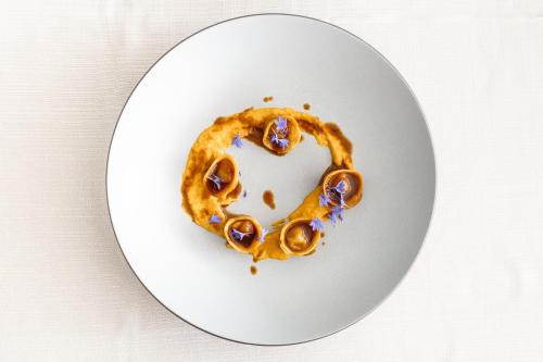 a white plate with a pretzel on it at Villa Waldkönigin in San Valentino alla Muta