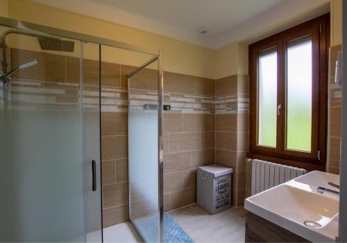 a bathroom with a glass shower and a sink at Gite de mavaleix in Chalais