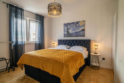 a bedroom with a bed with a yellow bedspread at Aurum Hills in Split