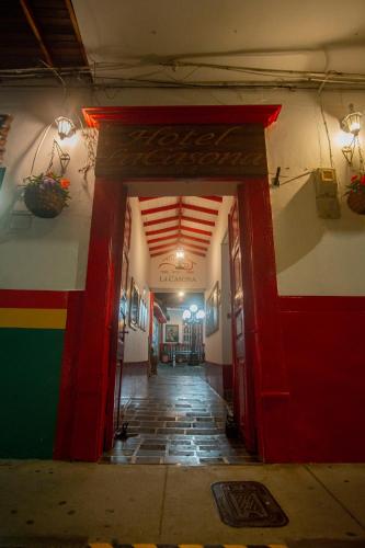a hallway with a red door in a building at Hotel La Casona in Jardin