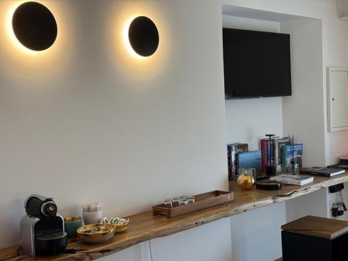 a kitchen with a wooden counter with a tv on the wall at Sea Tower Torre Telemetrica Lido di Venezia in Venice-Lido