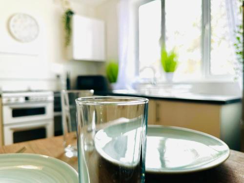 a glass of water sitting on a table in a kitchen at Brand New Lovely Flats by the Forest Tram Stop in Nottingham in Nottingham