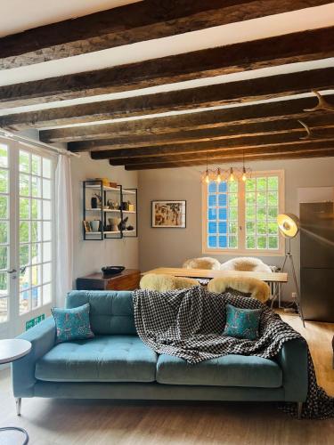 - un salon avec un canapé bleu et un lit dans l'établissement Castle like retreat next to the Dordogne River, à Argentat