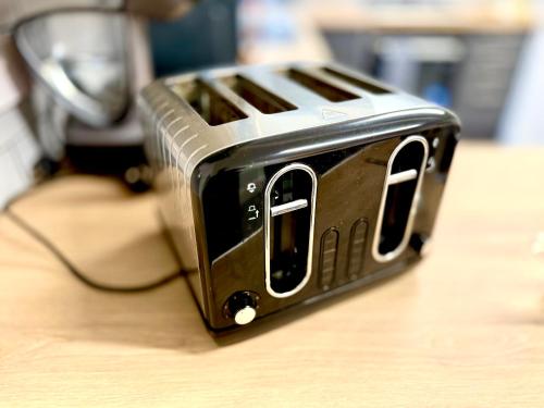 a black toaster sitting on top of a table at Brand New Lovely Flats by the Forest Tram Stop in Nottingham in Nottingham