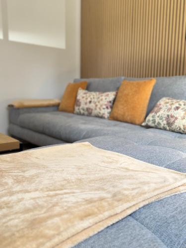 a blue couch with pillows on it in a living room at Mahesars Home in Gevelsberg