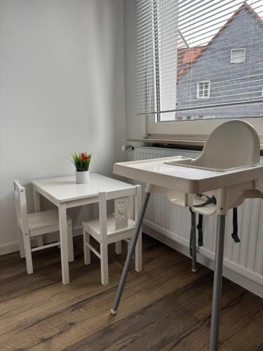 a white desk and chair next to a window at Mahesars Home in Gevelsberg