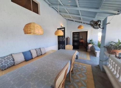 a dining room with a table and a couch at Casa Bonita in El Pescadero