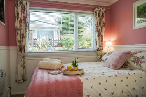 a bedroom with a bed with a table on it at South Devon - River Dart Views - Free Parking - Pet Friendly in Galmpton-on-the-Dart
