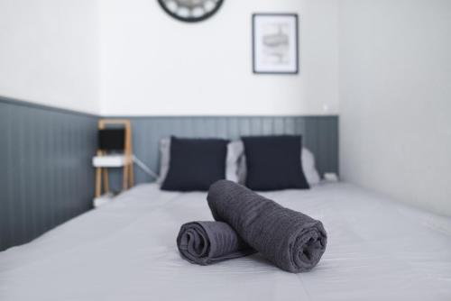a gray rolled up towel on a bed at Studio moderne - proximité gare et espace extérieur in Toulouse