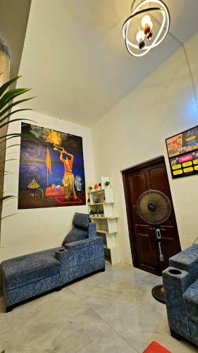 a living room with a couch and a painting on the wall at Elephant House Boutique Stays- BHU- BLW in Varanasi