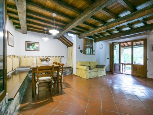 a living room with a table and a couch at Holiday Home Bellavista - Villi by Interhome in Montieri