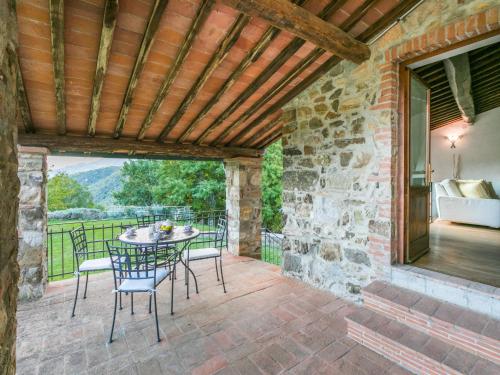 an outdoor patio with a table and chairs at Holiday Home Bellavista - Villi by Interhome in Montieri