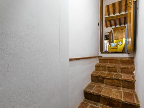a stairway with a mirror in a white wall at Holiday Home Bellavista - Villi by Interhome in Montieri