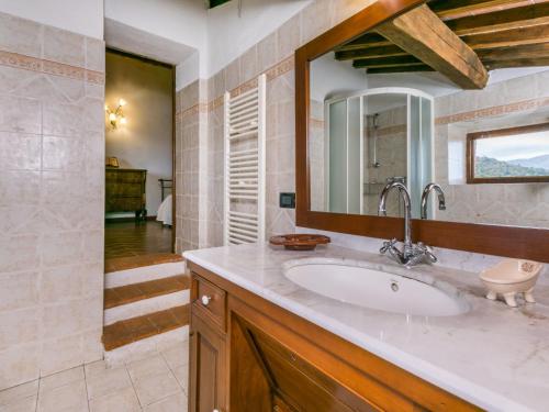 a bathroom with a sink and a mirror at Holiday Home Bellavista - Villi by Interhome in Montieri