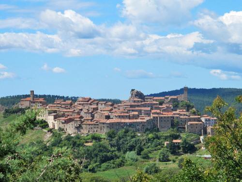 a town on top of a hill with houses at Holiday Home Oca by Interhome in Sticciano