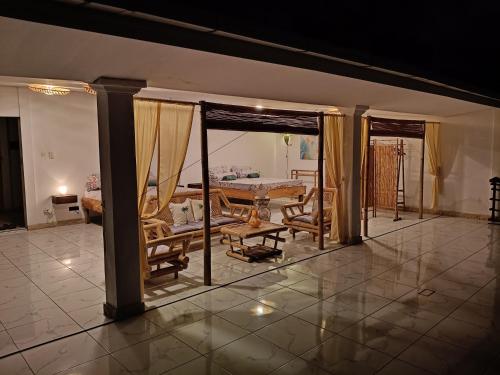 a large living room with a table and chairs at Skylodge B&B - Bali Jungle Retreat with Fine Dining & Eco Pool in Bukti