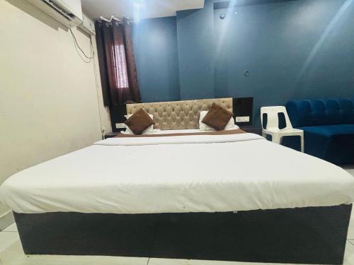 a bedroom with a large bed and a blue wall at Vijay Shree1 in Lucknow