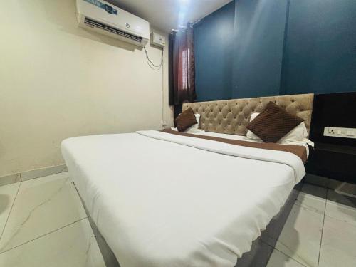 a large white bed in a room with at Vijay Shree1 in Lucknow