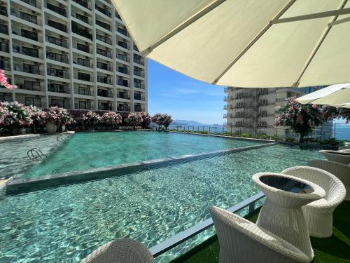 a swimming pool on the roof of a building at Gold Coast Apartment Seaview in Nha Trang