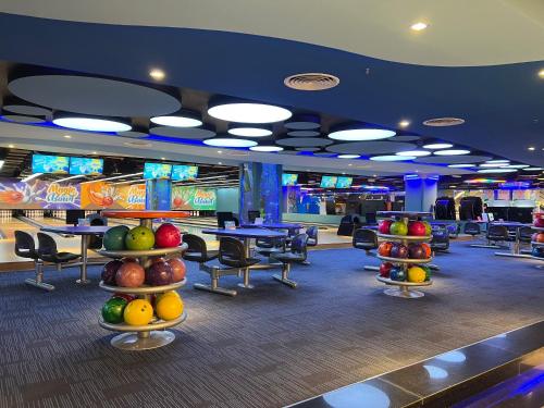 a bowling alley with fruit on display in a casino at Gold Coast Apartment Seaview in Nha Trang