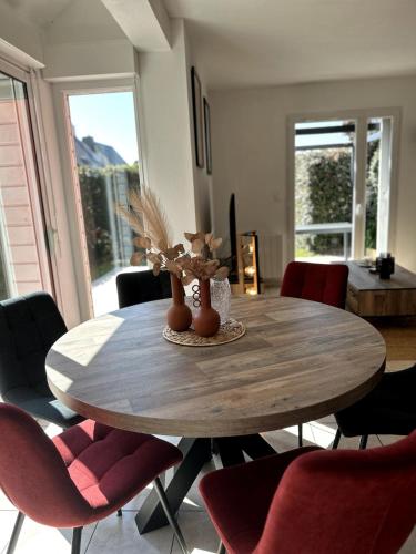 a dining room with a wooden table and chairs at Charlotte Lodge-House 4 pers-wifi-parking-Dinard in Dinard