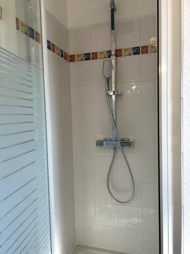 a shower with a shower head in a bathroom at Charlotte Lodge-House 4 pers-wifi-parking-Dinard in Dinard