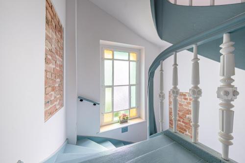 a stairway with a window and a brick wall at Monciak Comfort - Kamienica in Sopot