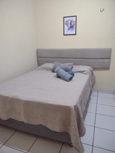 a bed with two pillows on it in a bedroom at Casa individual próximo a UFT in Palmas