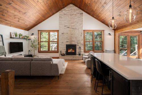 a living room with a couch and a fireplace at Chalet La Canopée -familial par excellence MontBlanc in Mont-Blanc
