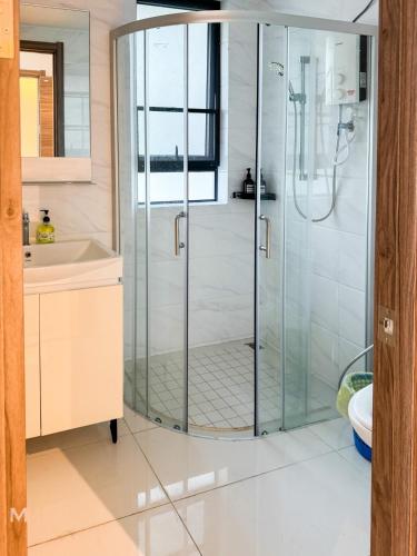 a glass shower in a bathroom with a sink at 3BR3B Hozem JB1306 Apartment Forest City in Gelang Patah